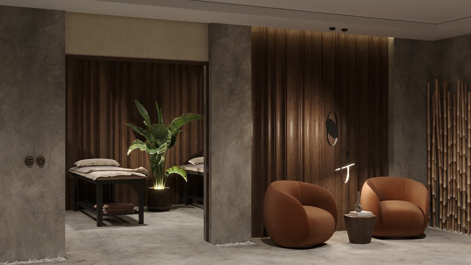 A calm spa treatment room with massage beds and warm lighting